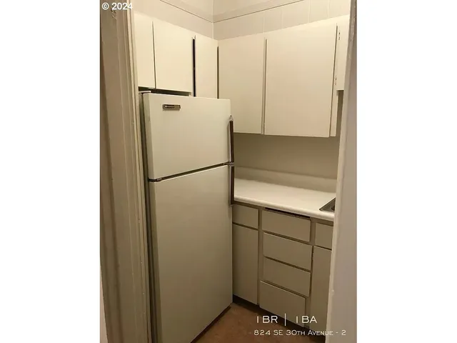 a kitchen with a sink cabinets and a window