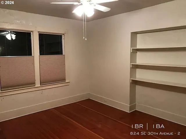 a view of an empty room with a cabinet
