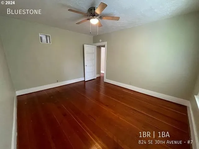 a view of room with wooden floor and window