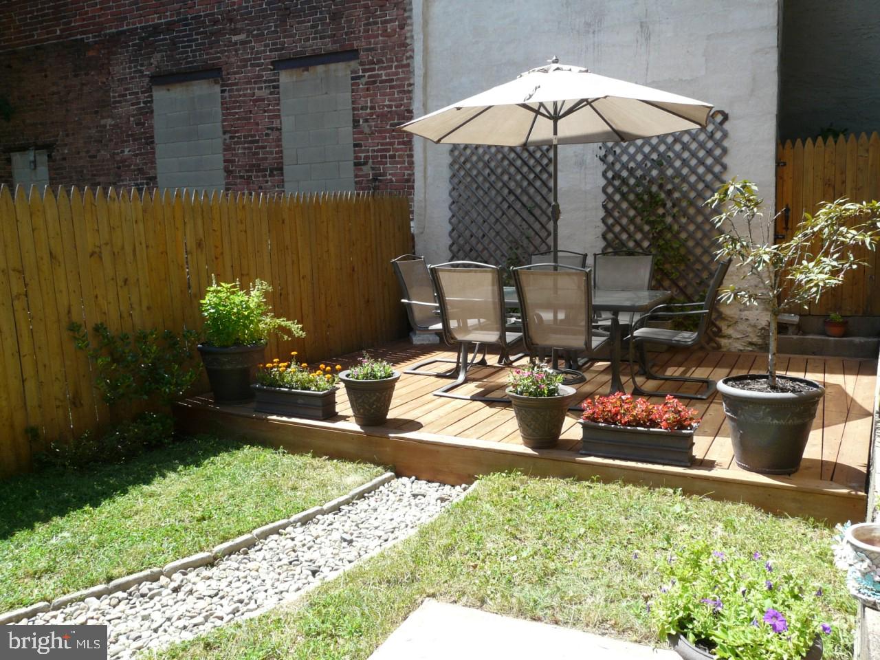 a view of a backyard with plants and patio