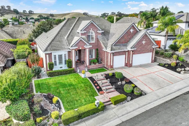 a front view of house with yard and green space