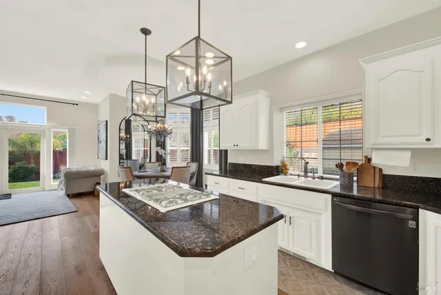 a living room with furniture stove and wooden floor
