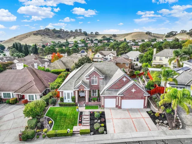 a view of a house with backyard porch and sitting area