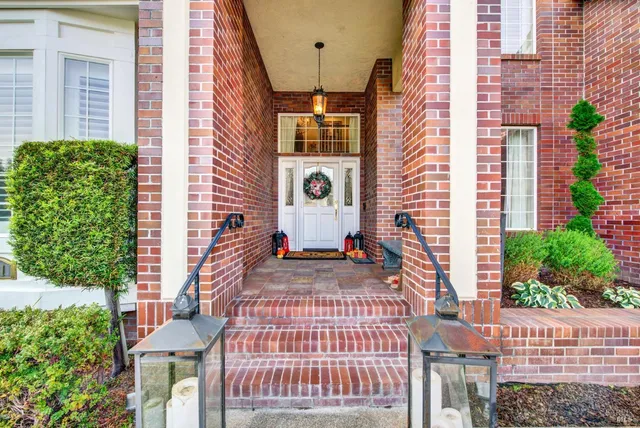 a kitchen with stainless steel appliances granite countertop a stove a sink a dining table and chairs