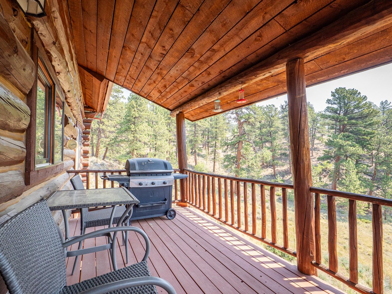 296 Caddo Road Red Feather Lakes, CO 80545 - Photo 13 of 50 Covered deck adjacent to great room/dining area.