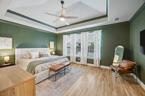 a bedroom with a large bed and a chandelier