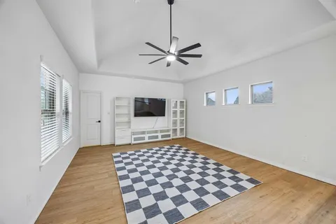 a view of a bedroom with wooden floor