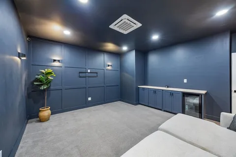 a bedroom with a bed and a mirror