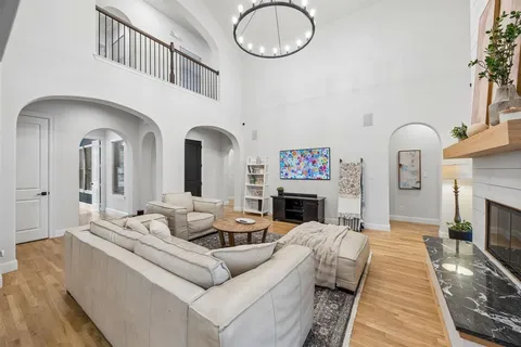 a living room with furniture a fireplace and a large mirror