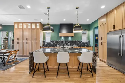 a dining room with furniture window and wooden floor
