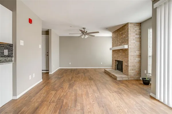 wooden floor in an empty room with a fireplace