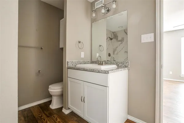 a bathroom with a sink toilet and shower