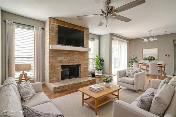 a living room with furniture a fireplace and a flat screen tv