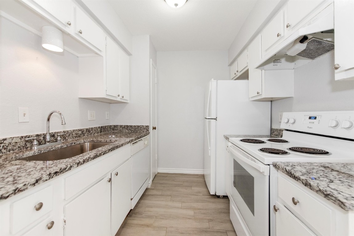 6200 West Tidwell Road, Unit 1613 Houston, TX 77092 - Photo 11 of 16 a kitchen with granite countertop a sink stove and refrigerator