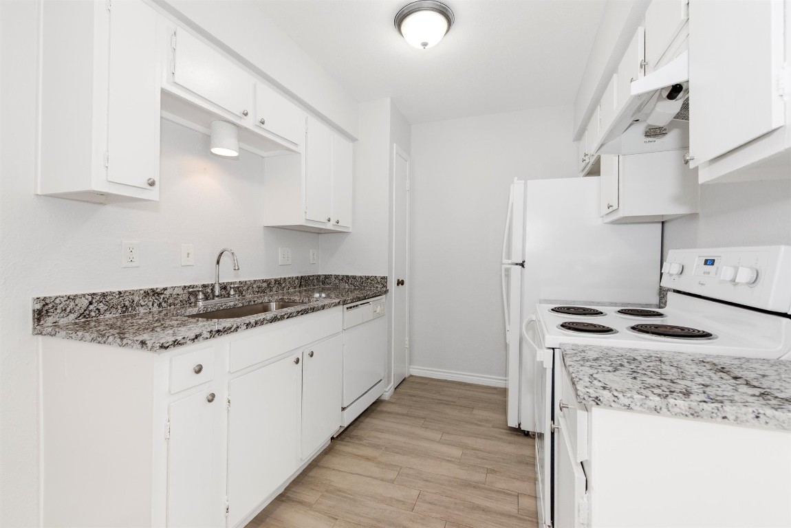 6200 West Tidwell Road, Unit 1613 Houston, TX 77092 - Photo 12 of 16 a kitchen with granite countertop a sink stove and cabinets