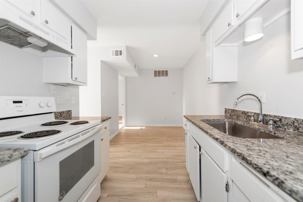 6200 West Tidwell Road, Unit 1613 Houston, TX 77092 - Photo 13 of 16 a kitchen with granite countertop a sink stove and cabinets