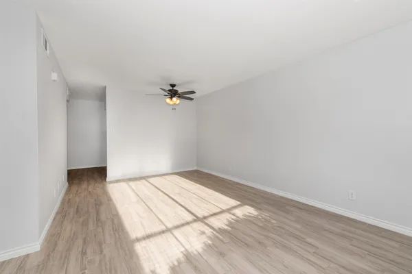 a view of an empty room and wooden floor