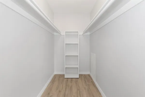 a view of a room with wooden floor