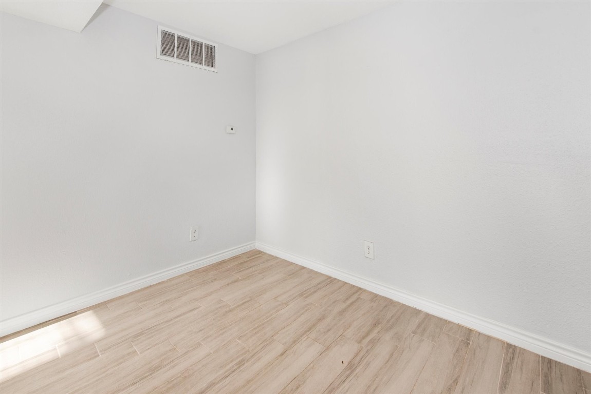 6200 West Tidwell Road, Unit 1613 Houston, TX 77092 - Photo 9 of 16 a view of an empty room with wooden floor