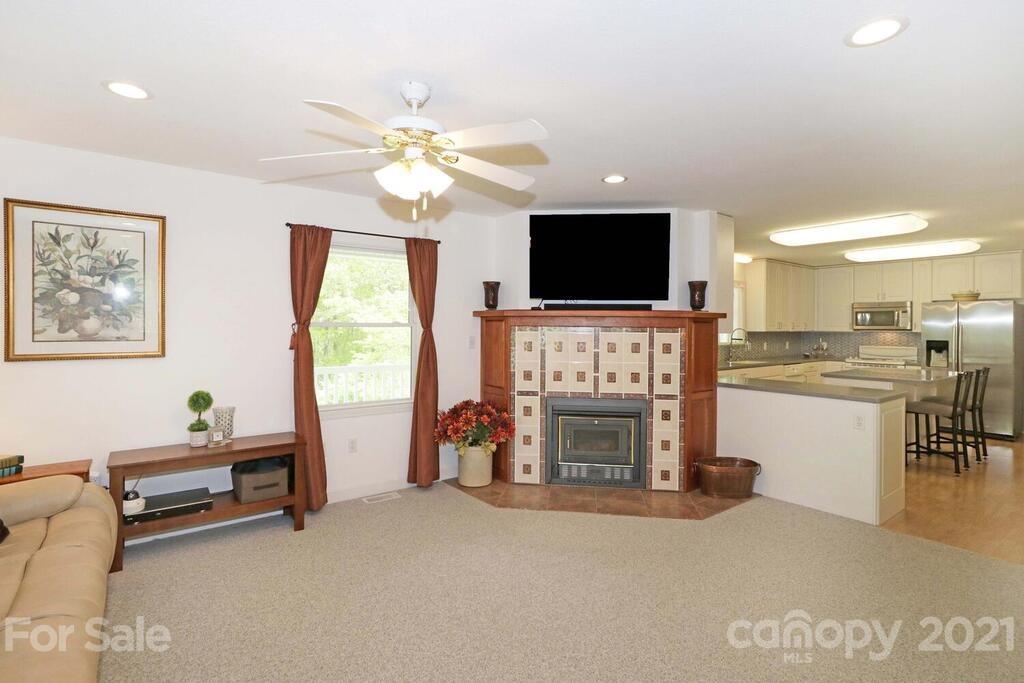 265 Deer Road Salisbury, NC 28146 - Photo 9 of 48 a living room with furniture a fireplace and a flat screen tv