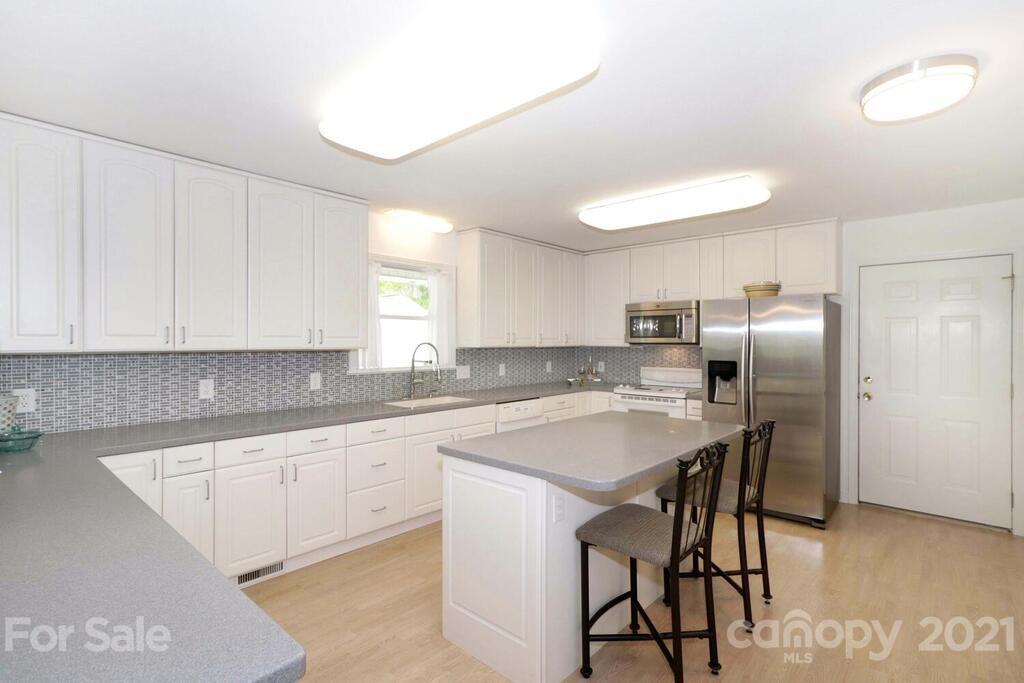 265 Deer Road Salisbury, NC 28146 - Photo 10 of 48 a kitchen with stainless steel appliances a table and chairs in it