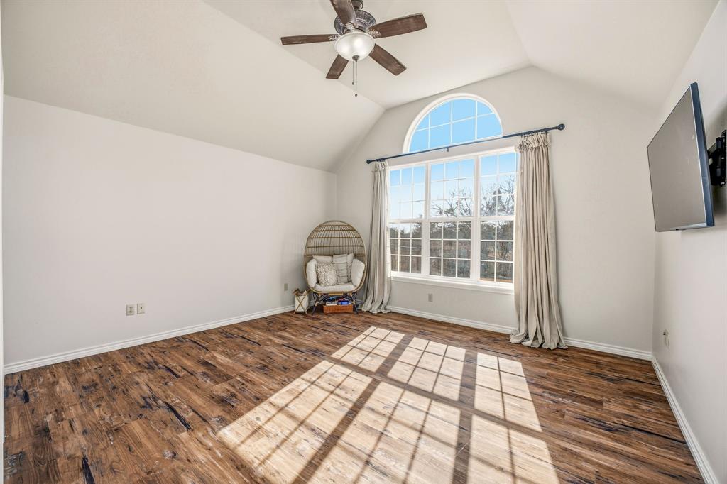 1114 Elk Ridge Drive Stephenville, TX 76401 - Photo 15 of 32 a view of a room with wooden floor fan and windows