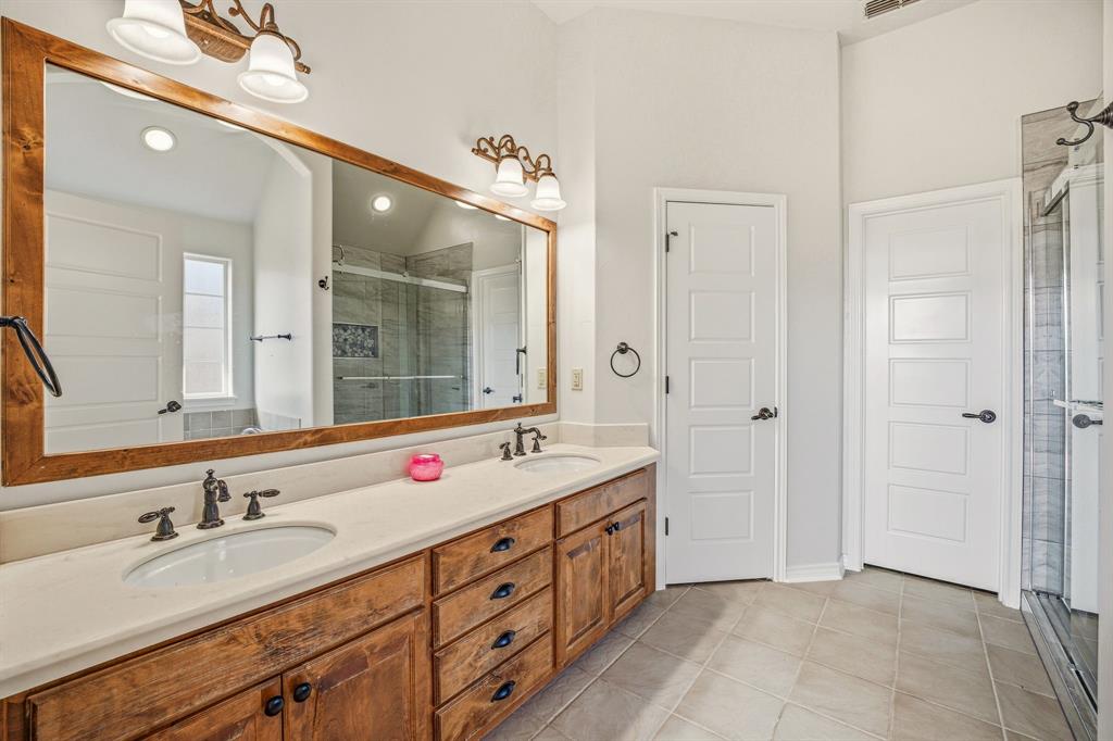 1114 Elk Ridge Drive Stephenville, TX 76401 - Photo 17 of 32 a spacious bathroom with double sink and a mirror