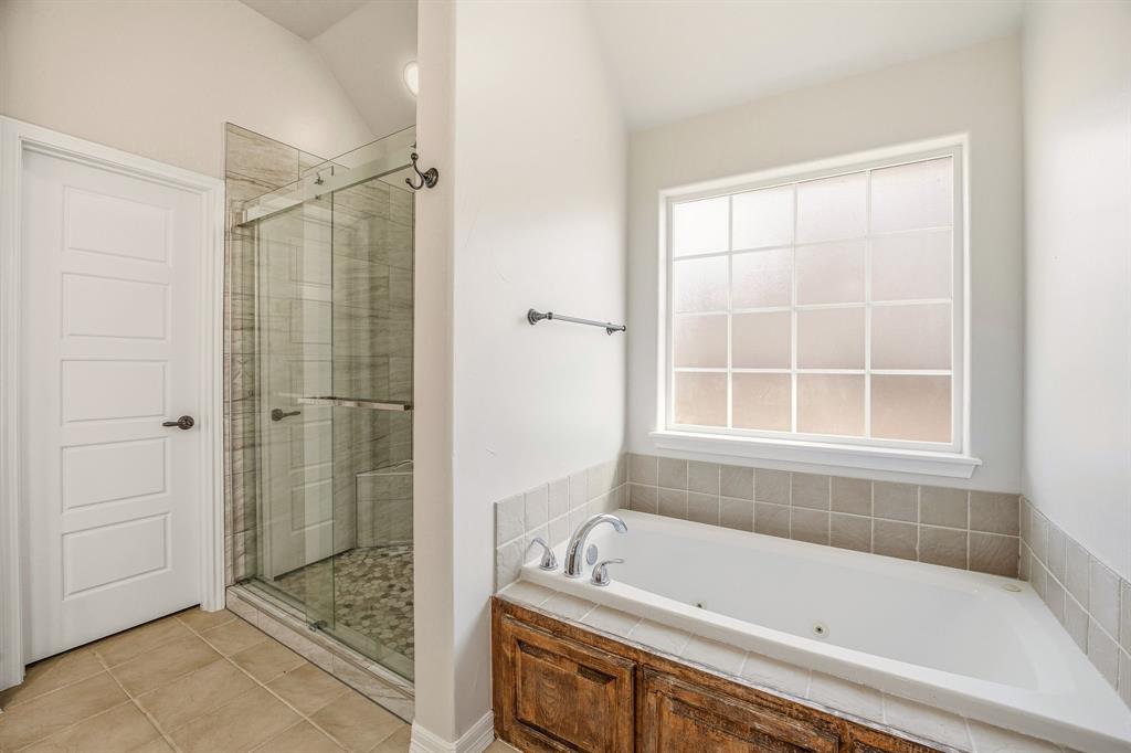 1114 Elk Ridge Drive Stephenville, TX 76401 - Photo 18 of 32 a bathroom with a tub shower and a sink