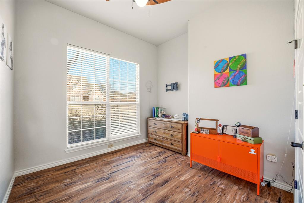 1114 Elk Ridge Drive Stephenville, TX 76401 - Photo 23 of 32 a room with wooden floor and furniture