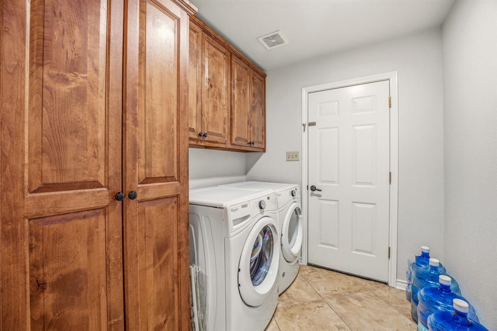 1114 Elk Ridge Drive Stephenville, TX 76401 - Photo 26 of 32 a view of a storage & utility room with dryer and washer
