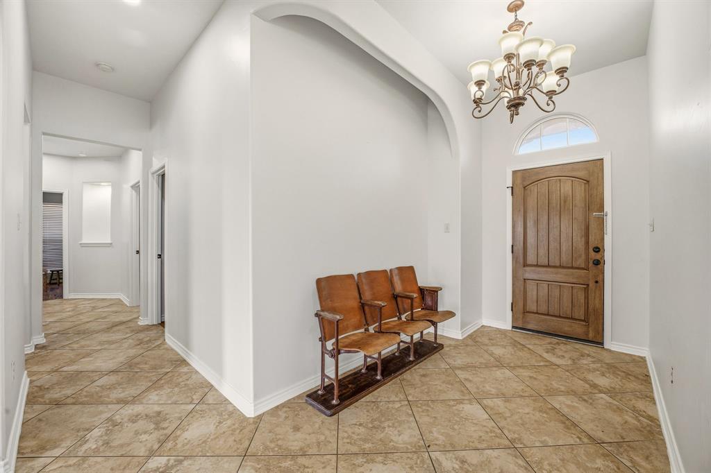 1114 Elk Ridge Drive Stephenville, TX 76401 - Photo 5 of 32 a living room with a chandelier