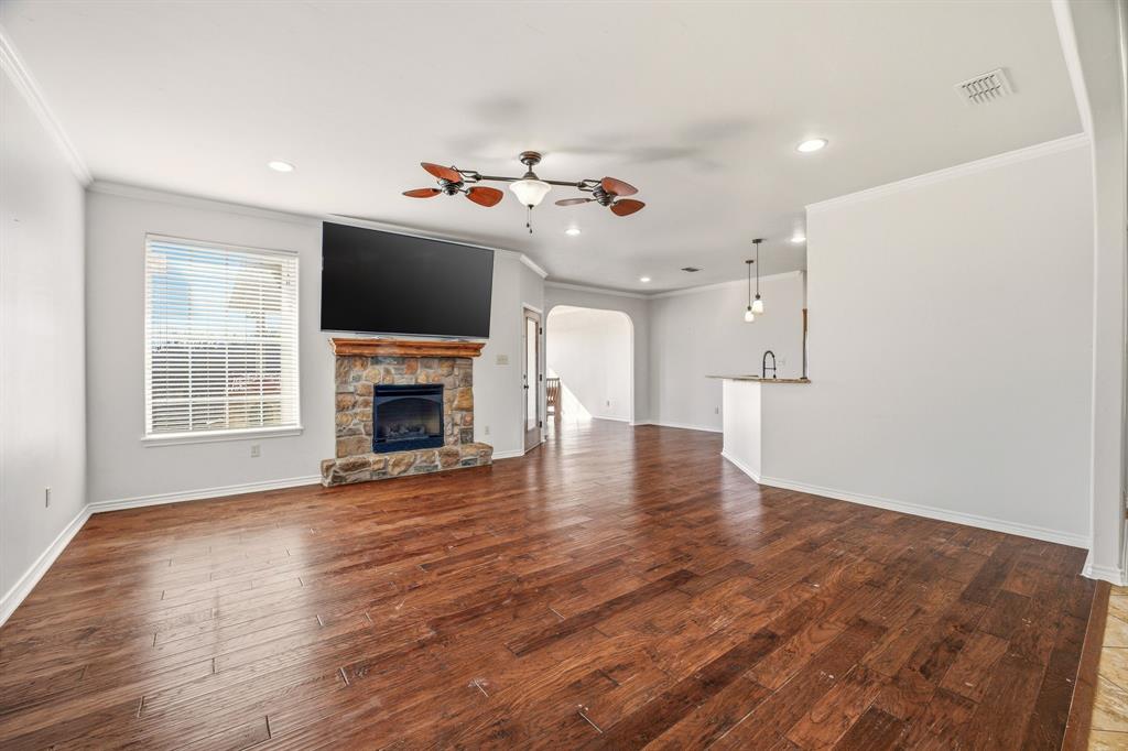 1114 Elk Ridge Drive Stephenville, TX 76401 - Photo 8 of 32 a view of a livingroom with wooden floor and a fireplace