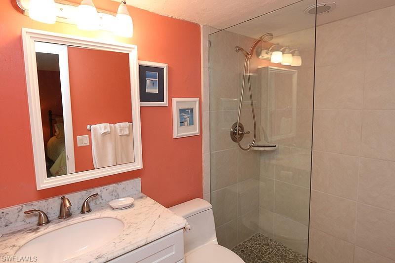 341 3rd Avenue South, Unit 341 Naples, FL 34102 - Photo 15 of 18 a bathroom with a sink a toilet and shower