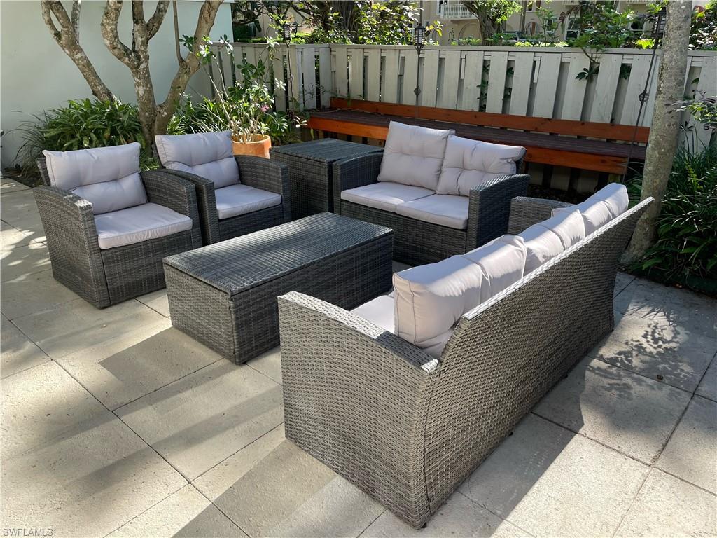341 3rd Avenue South, Unit 341 Naples, FL 34102 - Photo 2 of 18 a outdoor living space with furniture and a garden
