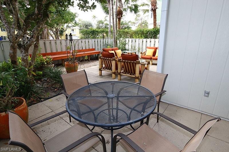 341 3rd Avenue South, Unit 341 Naples, FL 34102 - Photo 4 of 18 a view of a chairs and table in the patio