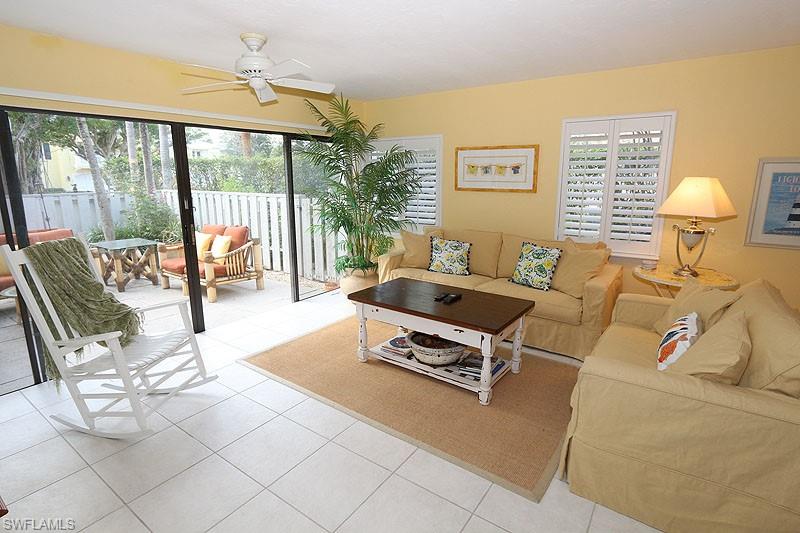 341 3rd Avenue South, Unit 341 Naples, FL 34102 - Photo 5 of 18 a living room with furniture and a large window