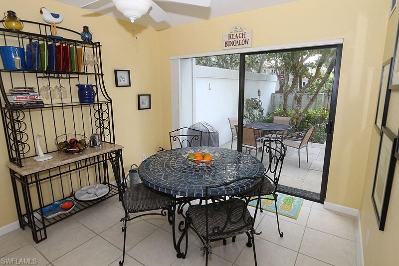 341 3rd Avenue South, Unit 341 Naples, FL 34102 - Photo 8 of 18 a view of a dining room with furniture window and wooden floor