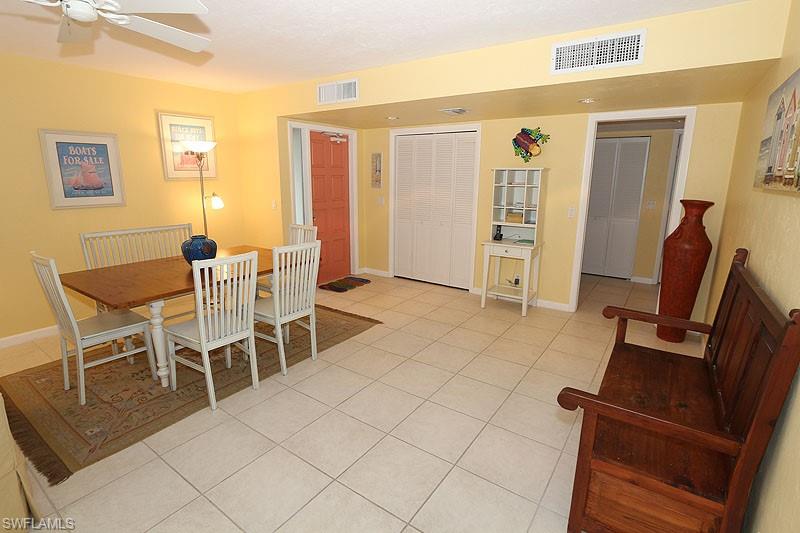 341 3rd Avenue South, Unit 341 Naples, FL 34102 - Photo 10 of 18 a dining room with furniture and wooden floor