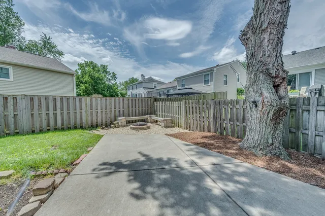 a view of a backyard with a small cabin and a chair