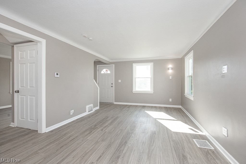 19109 Libby Road Maple Heights, OH 44137 - Photo 2 of 32 Spare room featuring light hardwood / wood-style floors and ornamental molding