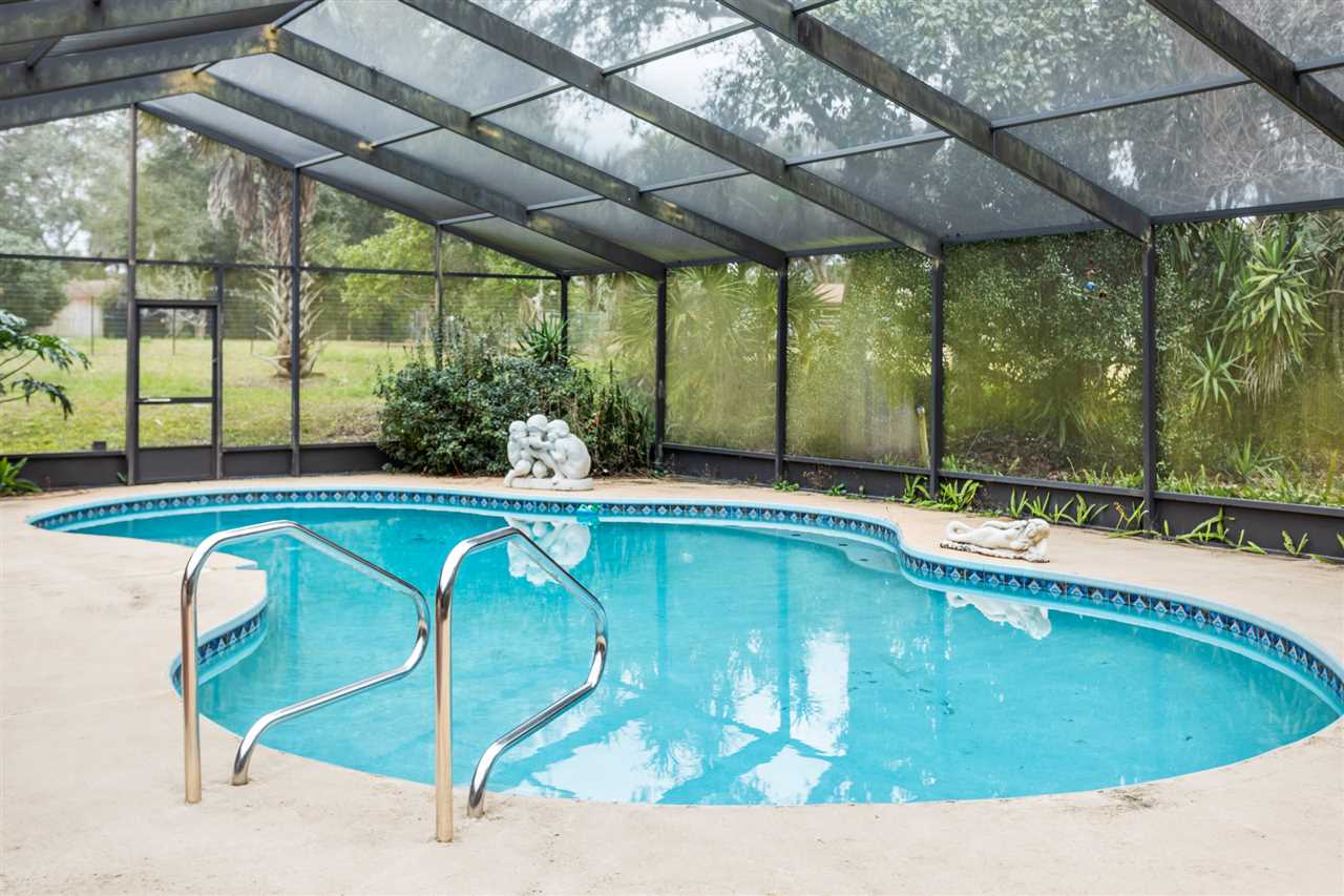 480 Vaill Point Road St. Augustine, FL 32086 - Photo 1 of 11 a swimming pool with outdoor seating and yard