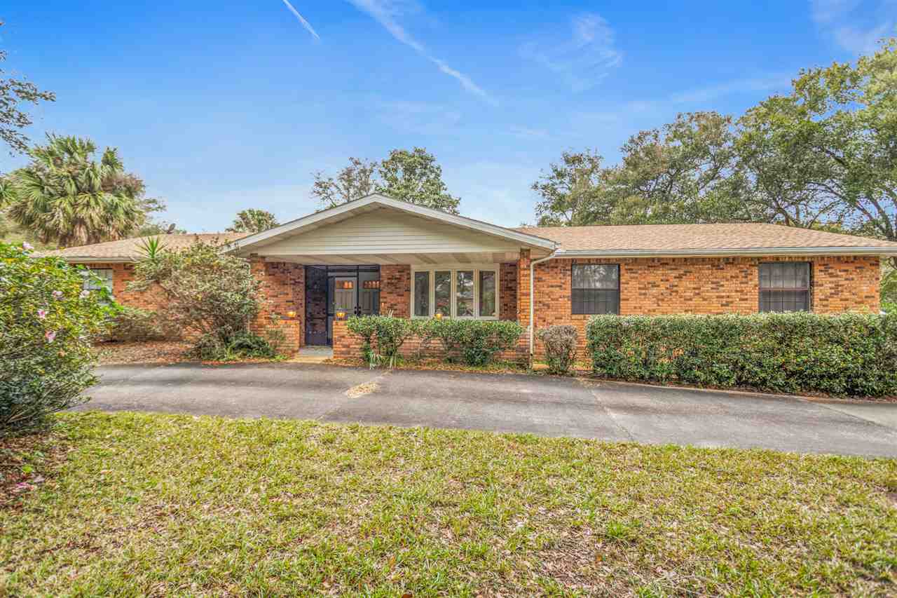 480 Vaill Point Road St. Augustine, FL 32086 - Photo 2 of 11 a front view of a house with a yard