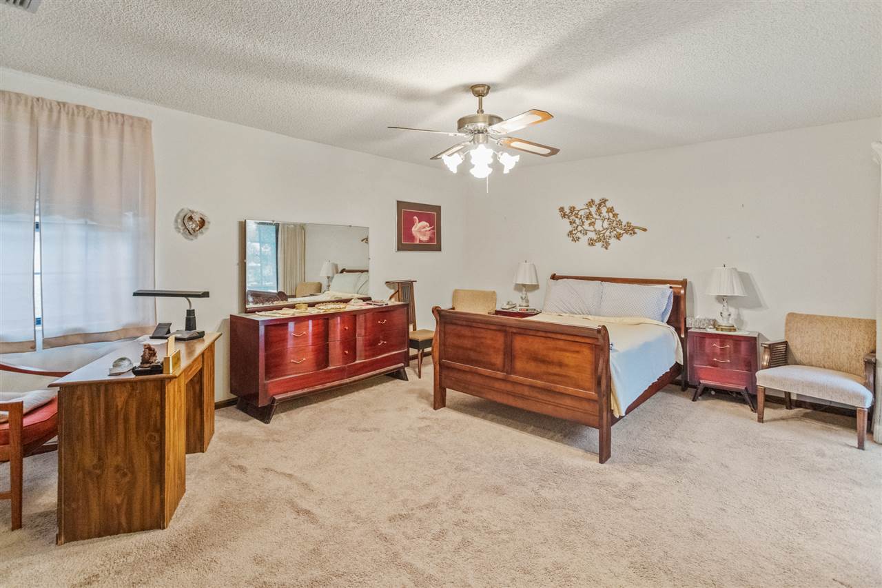 480 Vaill Point Road St. Augustine, FL 32086 - Photo 6 of 11 a bedroom with a bed and a chandelier