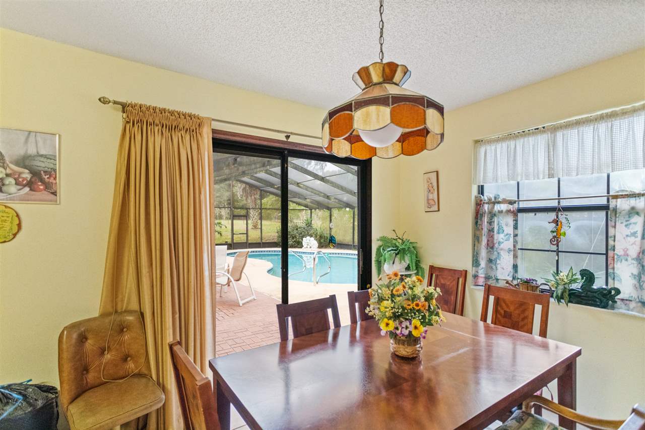 480 Vaill Point Road St. Augustine, FL 32086 - Photo 9 of 11 a dining room with furniture and wooden floor