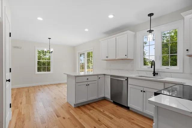 a kitchen with a sink window and cabinets