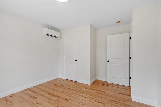a view of room with wooden floor