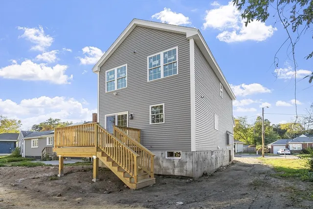 a view of a house with a yard and wooden fence
