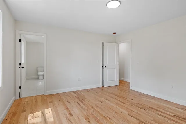 a view of a room with wooden floor and bathroom