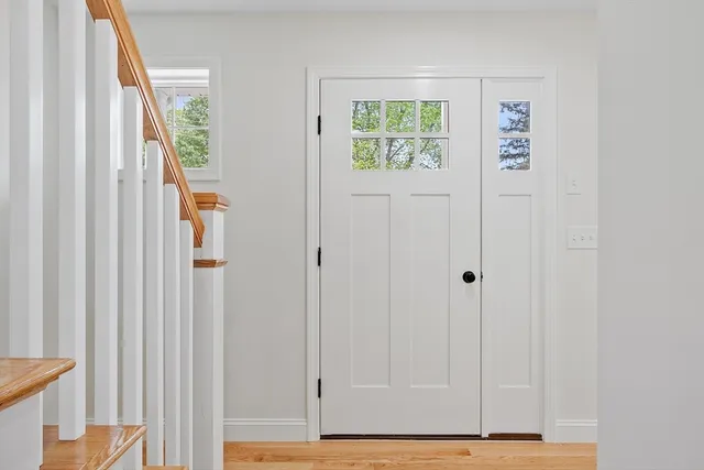 a view of an entryway with wooden floor