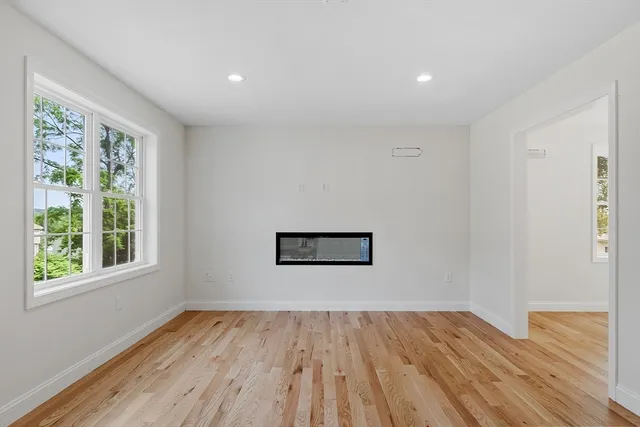 a view of a room with wooden floor and window